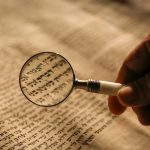 magnifying glass on Hebrew text